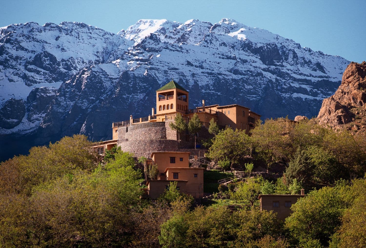 Kasbah du Toubkal in front of the snow-capped High Atlas Mountains